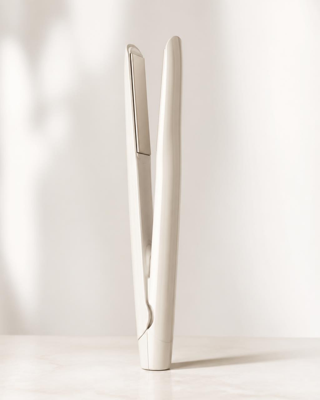 Arizele styling tool resting on warm ivory linen